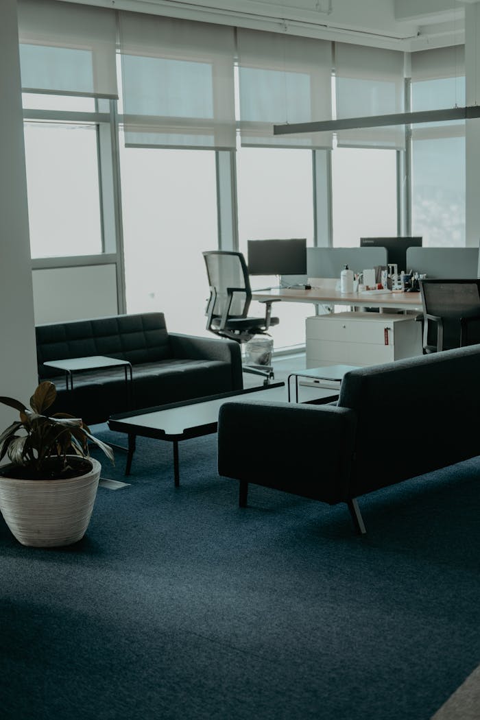 A stylish office space with leather sofas and large windows. Perfect for business settings.